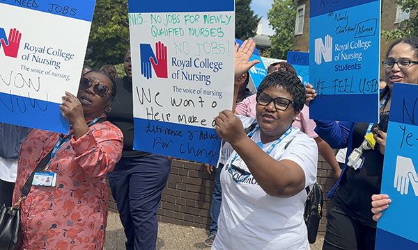 Final-year nursing students hold placards as they protest about the lack of nursing roles outside Croydon University Hospital, south London