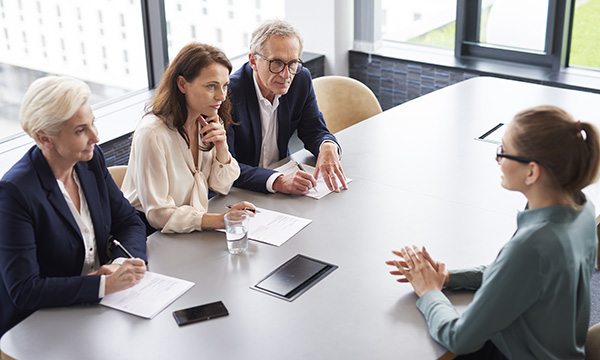 Competency-based job interview: candidate facing a panel of three interviewers