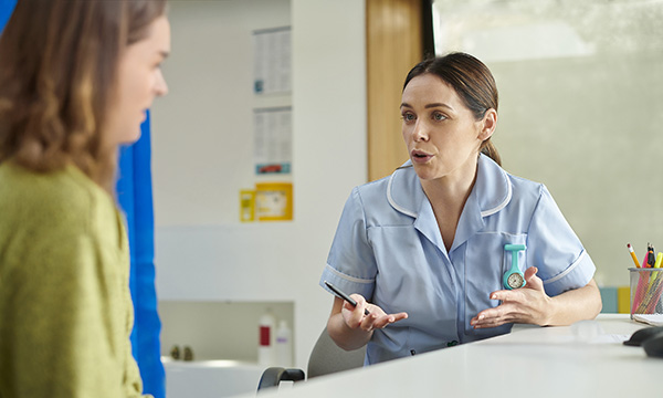 A nurse in conversation with a patient. Rather than directing patients in what they should, could, must or need to do, motivational interviewing enables them to exercise autonomy