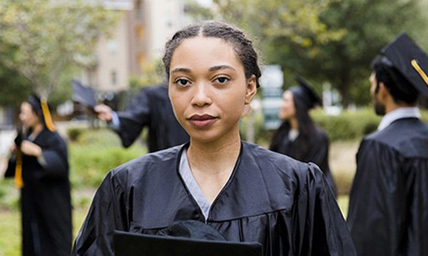 Nursing graduate jobs crisis: young woman in graduation gown