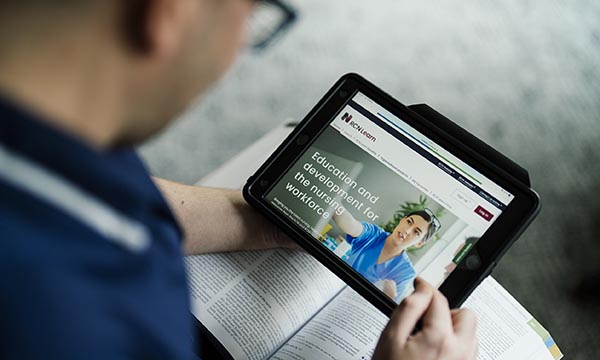 CPD for nurses: a nurse studying via the RCNi Learn website on an electronic pad