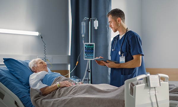 Male nurse assessing a deterioraing patient using the ABCDE approach