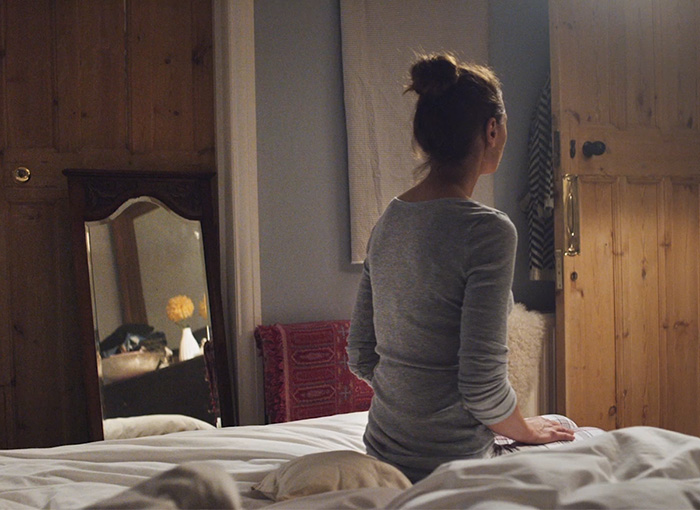 Someone sitting on a bed