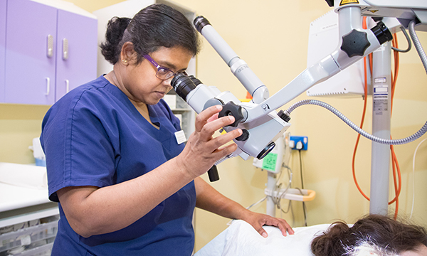 Christy Samuel examining a patient
