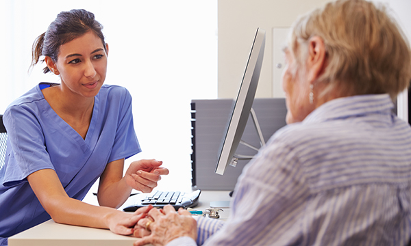 GP nurse with patient