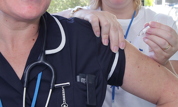 Nurse having flu jab