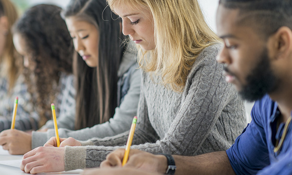 students sit written exam