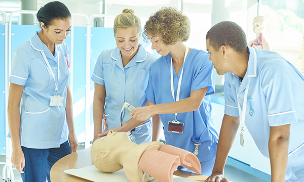 Three nurses undergoing training by a fourth nurse