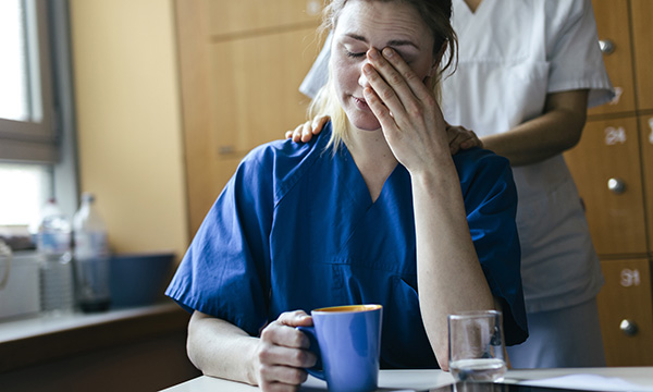 nurse looks stressed and tired