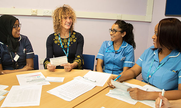 Ruth Miller with several colleagues sat round a table