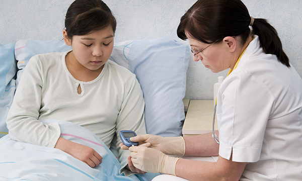 A nurse treating a young girl