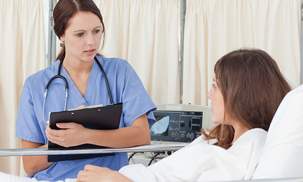 nurse at patient's bedside