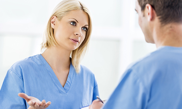 Picture shows two medics in discussion. Lack of personal protective equipment allows nurses to take a decision to protect themselves, RCN guidance says.