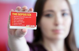 Katie Dutton holds the sepsis six card