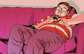 Young obese man lies on the sofa playing computer games