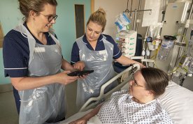 Rachael Ward and Corrine Shore undertaking a pain assessment with a patient