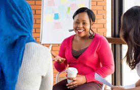 women smile and talk together