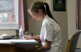 Reflective journalling: a nursing student writing at a desk, as if keeping a journal to process difficult events and record positive experiences