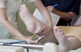 Pressure ulcer screening: nurses check the status of skin on the patient’s heel using a mirror