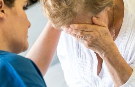 Breaking bad news: a nurse comforts a patient’s relative after breaking bad news about their care
