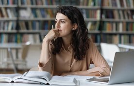 Practising reflection: a nursing student sits at a desk in a library