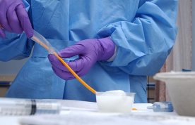 Aseptic technique: a healthcare professional working in a clinical setting wearing personal protective equipment