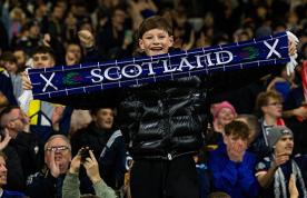 Young boy in crowd of Scottish football supporters – nurses in Scotland's NHS to be included in bank holiday to celebrate men's football world cup 