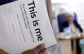 A 'This is me' form and an elderly male patient in the background