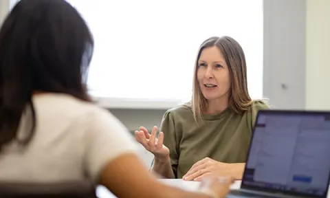 A confident-looking senior nurse being interviewed by a potential employer