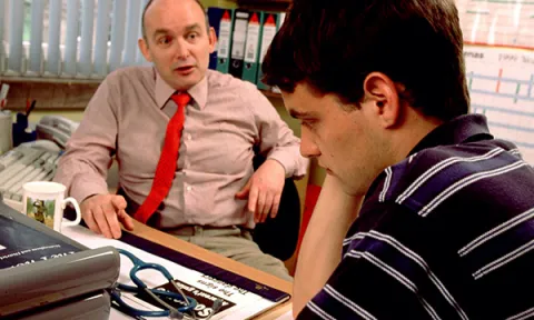 Pictures shows a GP talking to a young man. People with cancer who skip urgent referral appointments for their symptoms are more likely to die within a year of diagnosis, researchers say