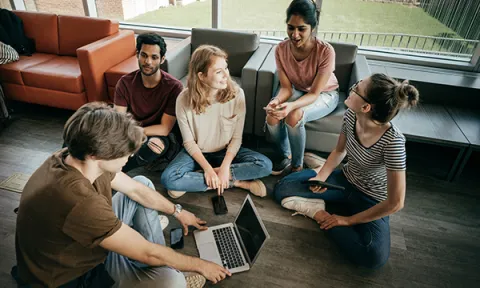 Picture shows a group of young people engaged in friendly conversation. Senior research nurse Heather Rostron examined the attitudes of investigators who recruit children and young people as advisers for research projects.