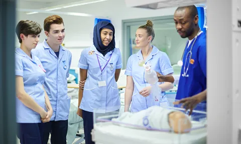 Children and young people nursing students learn and ask questions about baby incubation in a simulated exercise