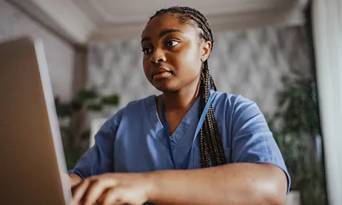 Developing and enhancing digital skills: picture shows a nursing student working on her laptop