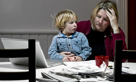A woman sitting with a child on her knee