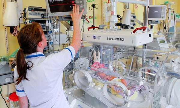 Nurse and baby in incubator