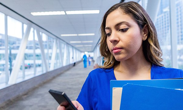 A nurse using her smart phone to access social media