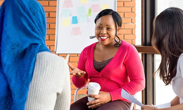 women smile and talk together