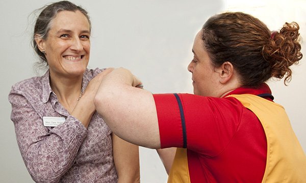 NHS staff member receives her flu jab