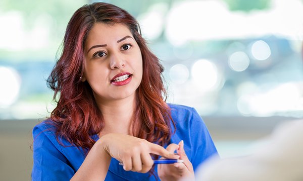 woman talking in an interview situation – thorough preparation helps nurses impress prospective employers at interview