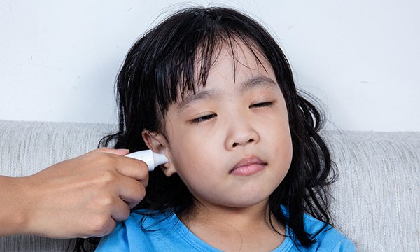 Girl having temperature taken