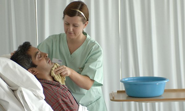 Nurse washing a patient
