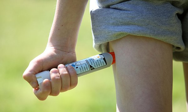 Picture shows a boy using an Epipen in his thigh, demonstrating what to do in the event of an anaphylactic shock. Lynne Regent of the charity Anaphylaxis Campaign outlines what nurses need to know to support people at risk from severe allergic reactions.