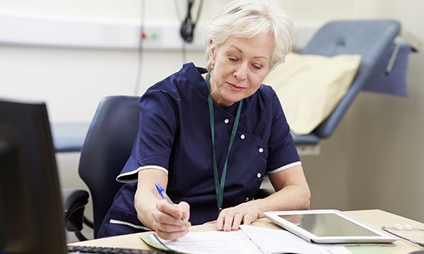 Picture shows a female medic sitting at a desk and writing. The health secretary’s humorous defence of his pledge on nurse numbers takes the focus off the real point, says James Buchan.