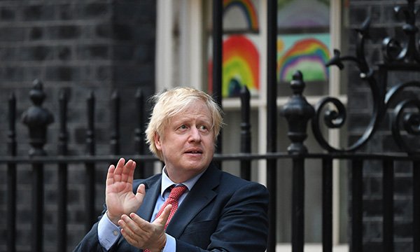 Prime Minister Boris Johnson applauding nurses and other health workers in Downing Street