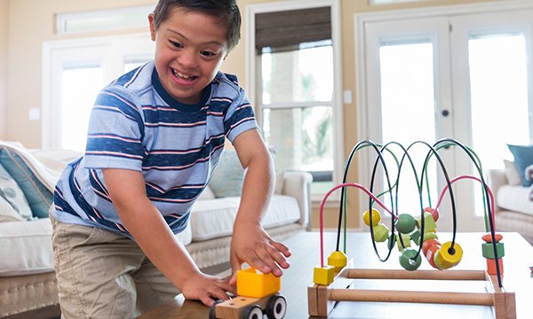 Picture shows a boy playing with toys