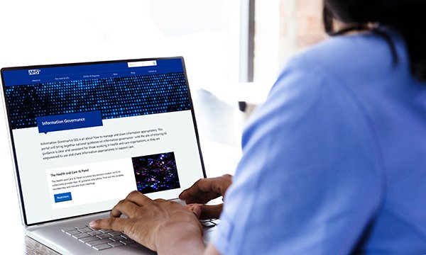 Picture shows a healthcare worker typing on a computer
