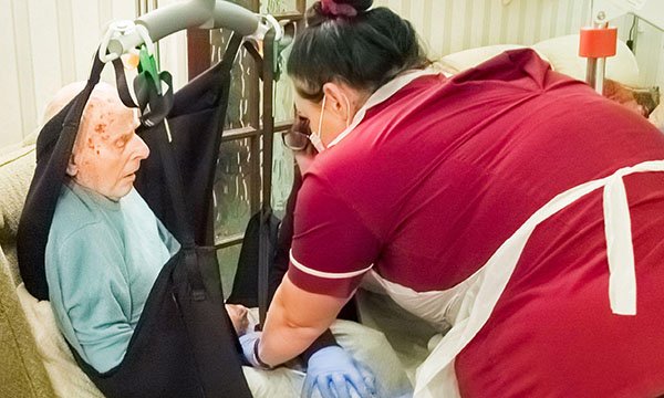 A care home resident being assisted by a nurse