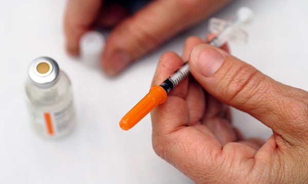 Picture shows a bottle of insulin and a syringe