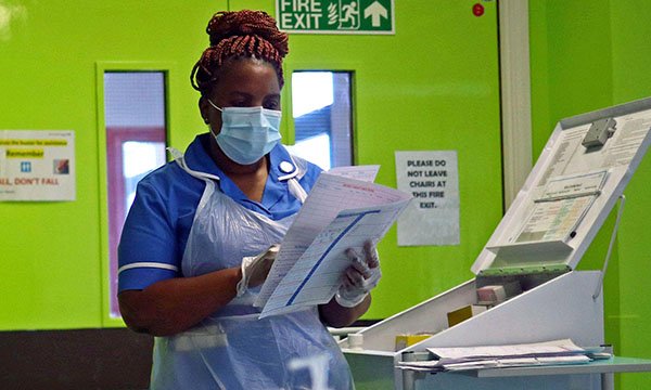 Picture shows a nurse at Royal Blackburn Teaching Hospital wearing a mask and apron.