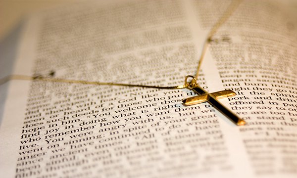 Cross necklace rests on a Bible – nurse takes ex-employer to tribunal, claiming it did not allow her to show this Christian symbol